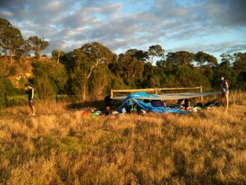 Tarp set for camping on the side of a river