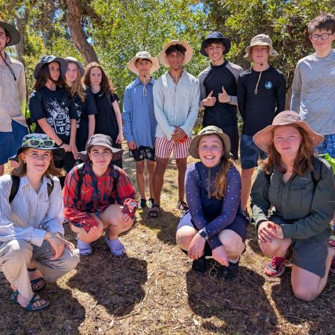 Group of campers standing in a group smiling at the camera
