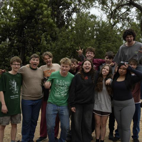 Group of campers standing together and laughing at the camera