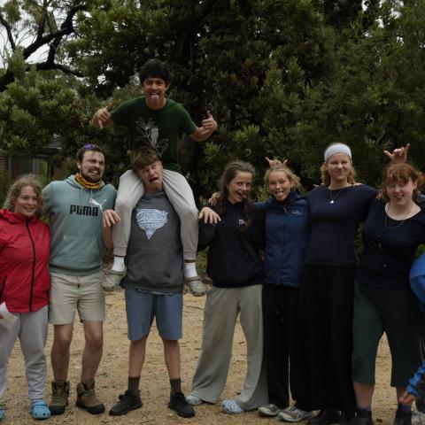 Group of campers standing in a group laughing at the camera