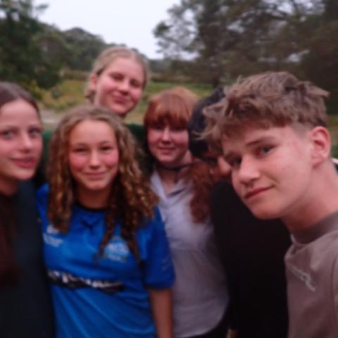 Group of campers standing in a group smiling at the camera