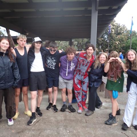 Group of campers standing in a group smiling at the camera
